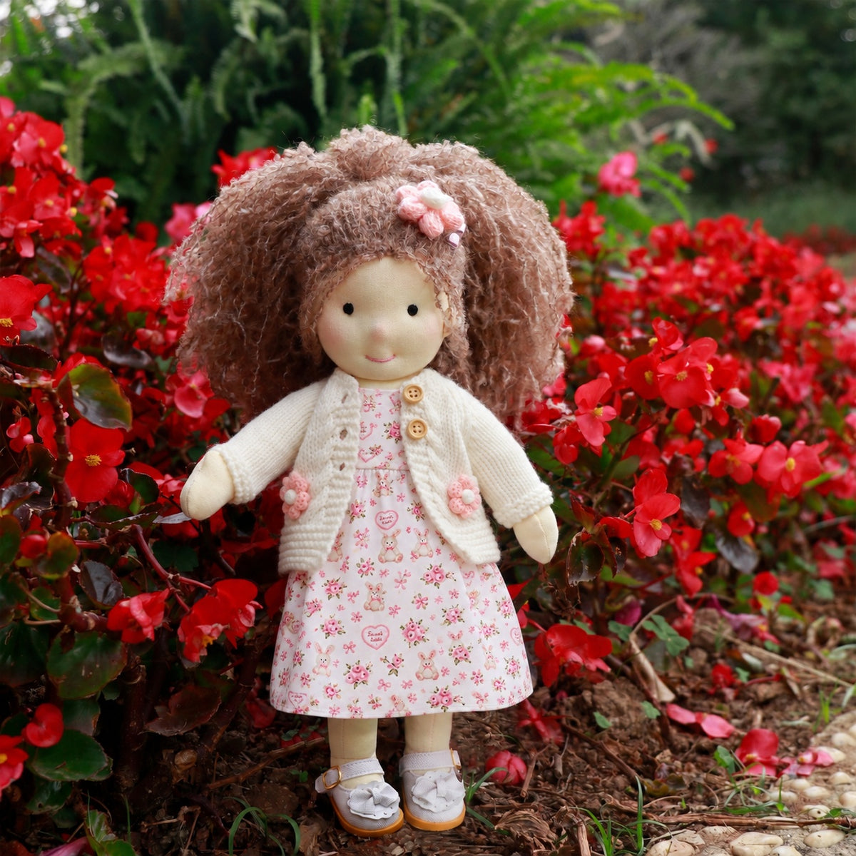 BlissfulPixie 12-Inch Waldorf-Style Doll with Brown Curly Hair, Pink Bow Hair Clip, Cream Knitted Cardigan, Bunny Print Dress & White Mary Jane Shoes – Cute Gift for Kids