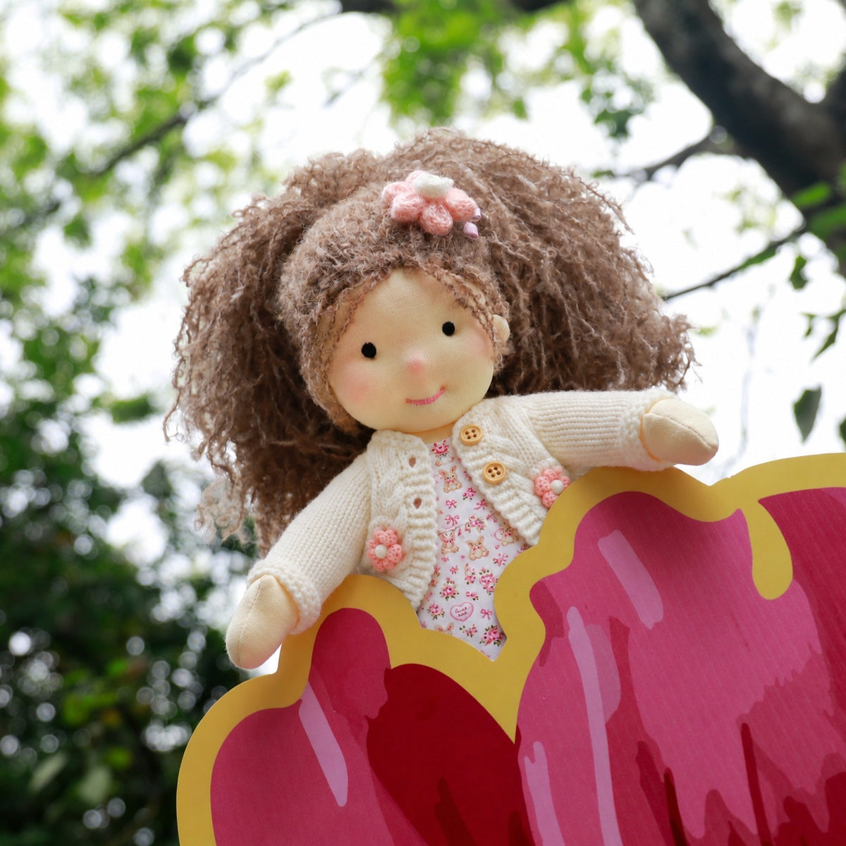 BlissfulPixie 12-Inch Waldorf-Style Doll with Brown Curly Hair, Pink Bow Hair Clip, Cream Knitted Cardigan, Bunny Print Dress & White Mary Jane Shoes – Cute Gift for Kids