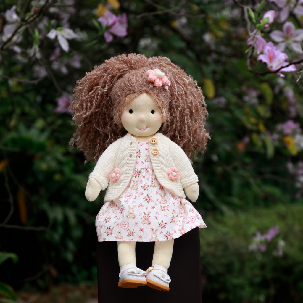 BlissfulPixie 12-Inch Waldorf-Style Doll with Brown Curly Hair, Pink Bow Hair Clip, Cream Knitted Cardigan, Bunny Print Dress & White Mary Jane Shoes – Cute Gift for Kids