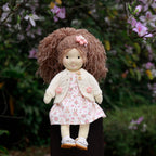 BlissfulPixie 12-Inch Waldorf-Style Doll with Brown Curly Hair, Pink Bow Hair Clip, Cream Knitted Cardigan, Bunny Print Dress & White Mary Jane Shoes – Cute Gift for Kids